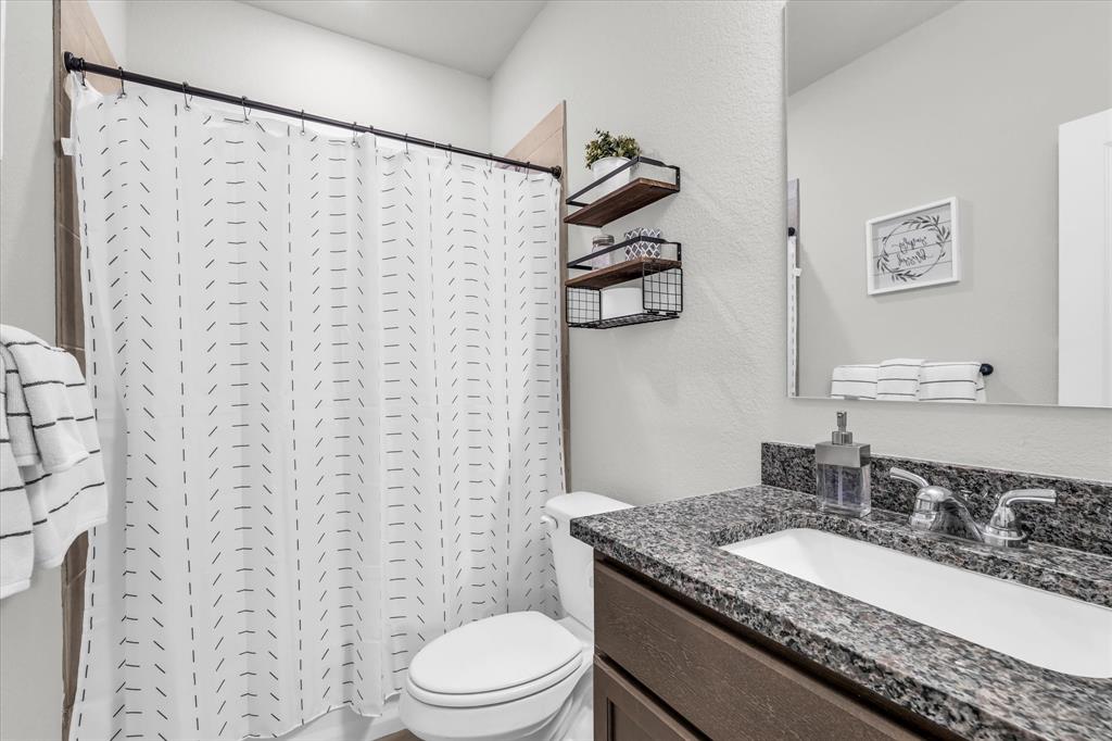 7008 Llano Drive China Spring, TX 76633 - Photo 21 of 26 a bathroom with a granite countertop sink and a mirror
