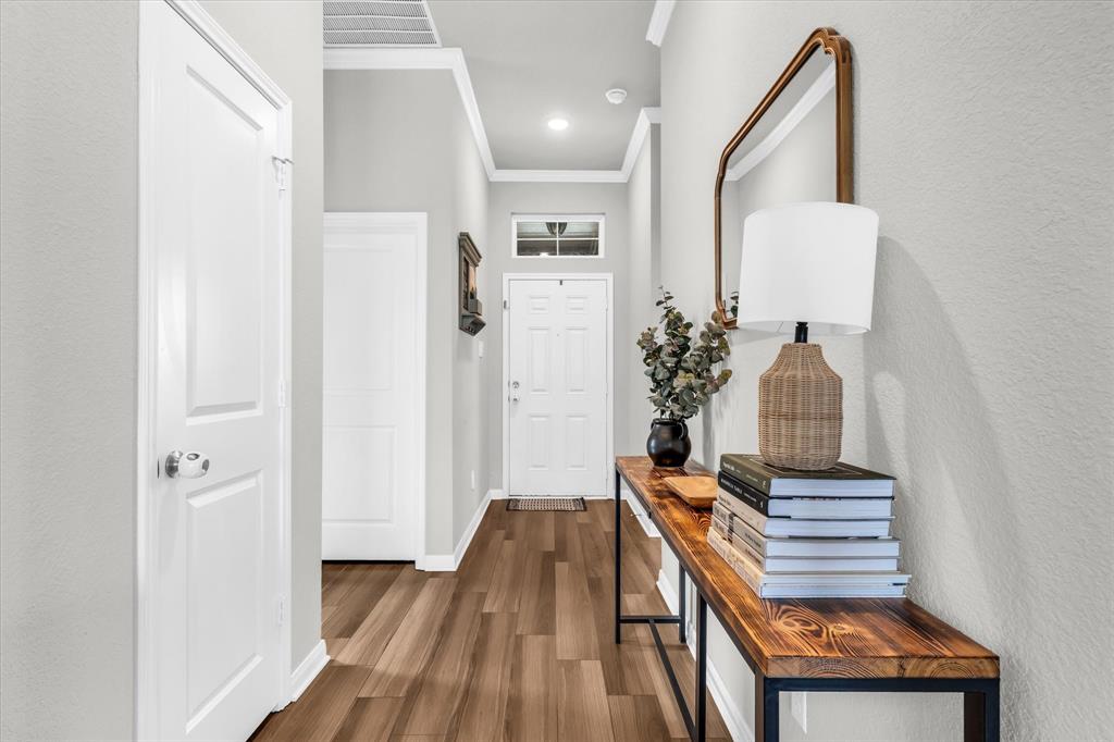 7008 Llano Drive China Spring, TX 76633 - Photo 4 of 26 a view of a hallway with entryway wooden floor and front door