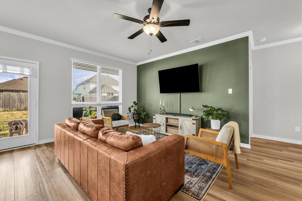 7008 Llano Drive China Spring, TX 76633 - Photo 5 of 26 a living room with furniture a flat screen tv and a floor to ceiling window