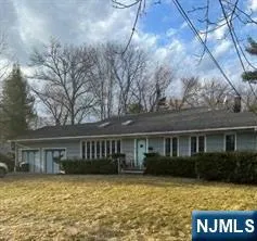 a view of house with yard and swimming pool