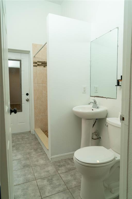 2906 West Chestnut Street, Unit 2 Tampa, FL 33607 - Photo 11 of 28 a bathroom with a sink a toilet and shower