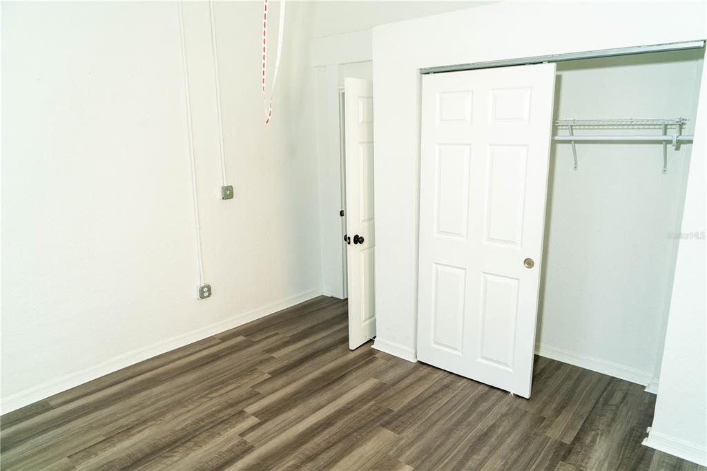 2906 West Chestnut Street, Unit 2 Tampa, FL 33607 - Photo 17 of 28 a view of an empty room with wooden floor