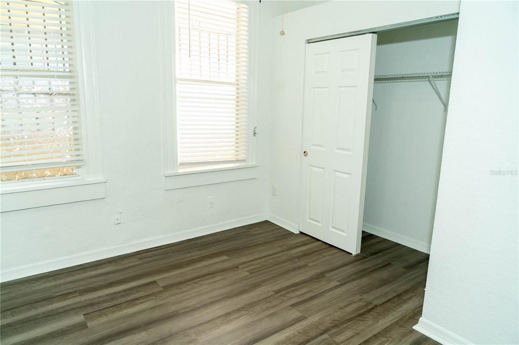 2906 West Chestnut Street, Unit 2 Tampa, FL 33607 - Photo 20 of 28 an empty room with wooden floor and windows