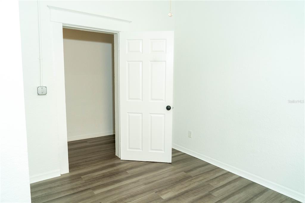2906 West Chestnut Street, Unit 2 Tampa, FL 33607 - Photo 21 of 28 a view of an empty room with wooden floor