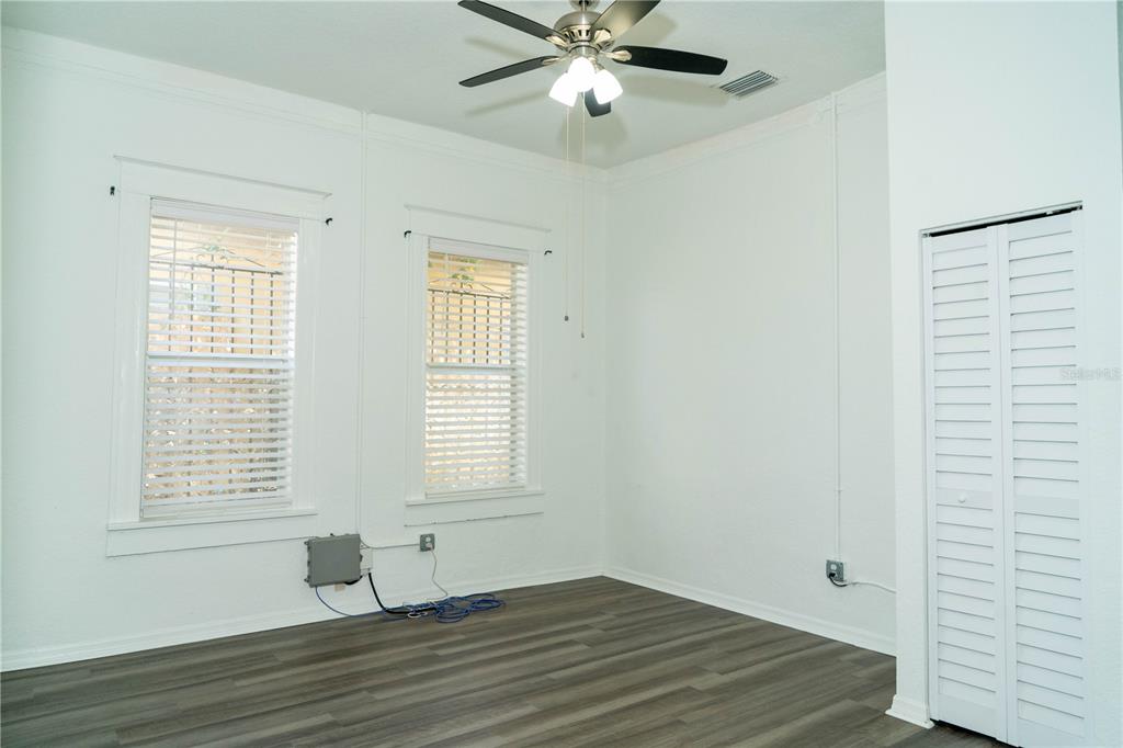 2906 West Chestnut Street, Unit 2 Tampa, FL 33607 - Photo 22 of 28 a view of empty room with wooden floor and fan