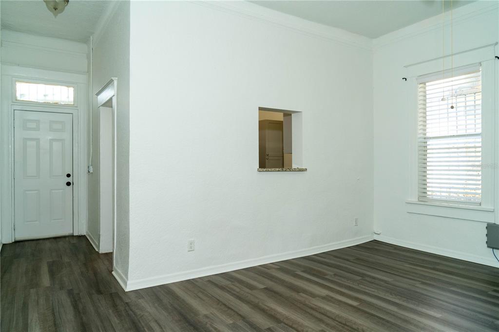 2906 West Chestnut Street, Unit 2 Tampa, FL 33607 - Photo 23 of 28 a view of an empty room with wooden floor and a window