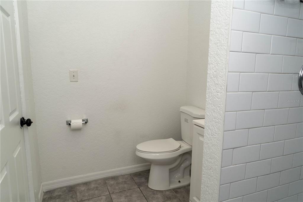 2906 West Chestnut Street, Unit 2 Tampa, FL 33607 - Photo 26 of 28 a bathroom with a toilet and a shower