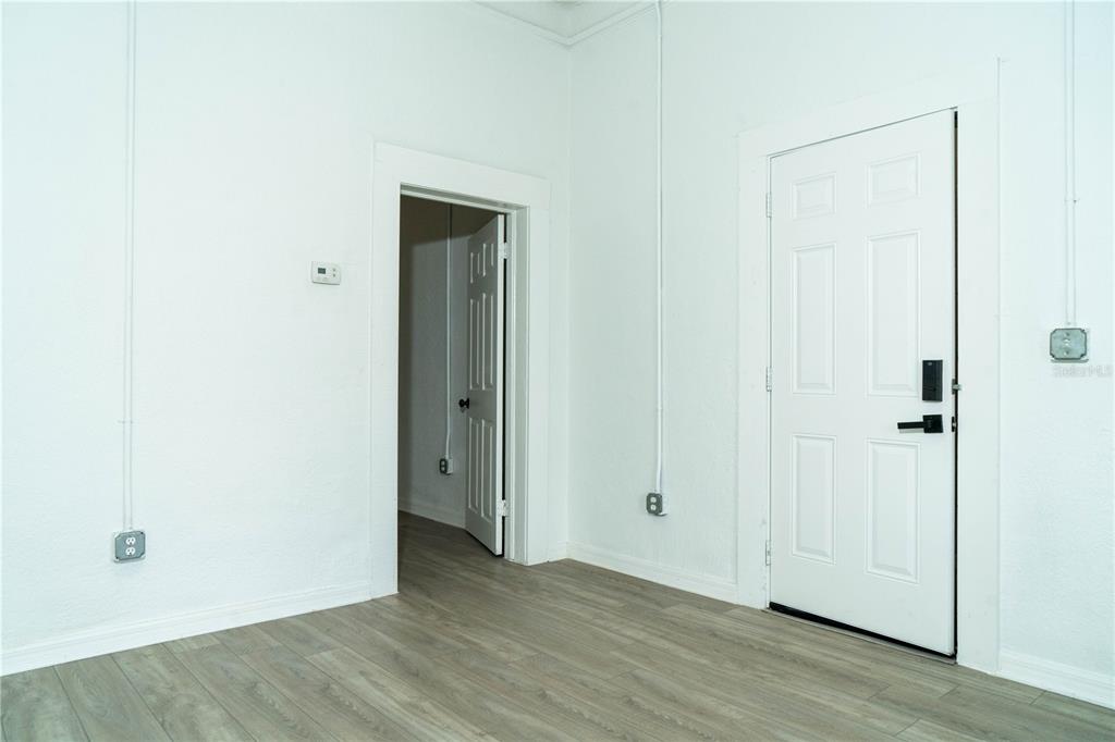 2906 West Chestnut Street, Unit 2 Tampa, FL 33607 - Photo 6 of 28 a view of an empty room with wooden floor