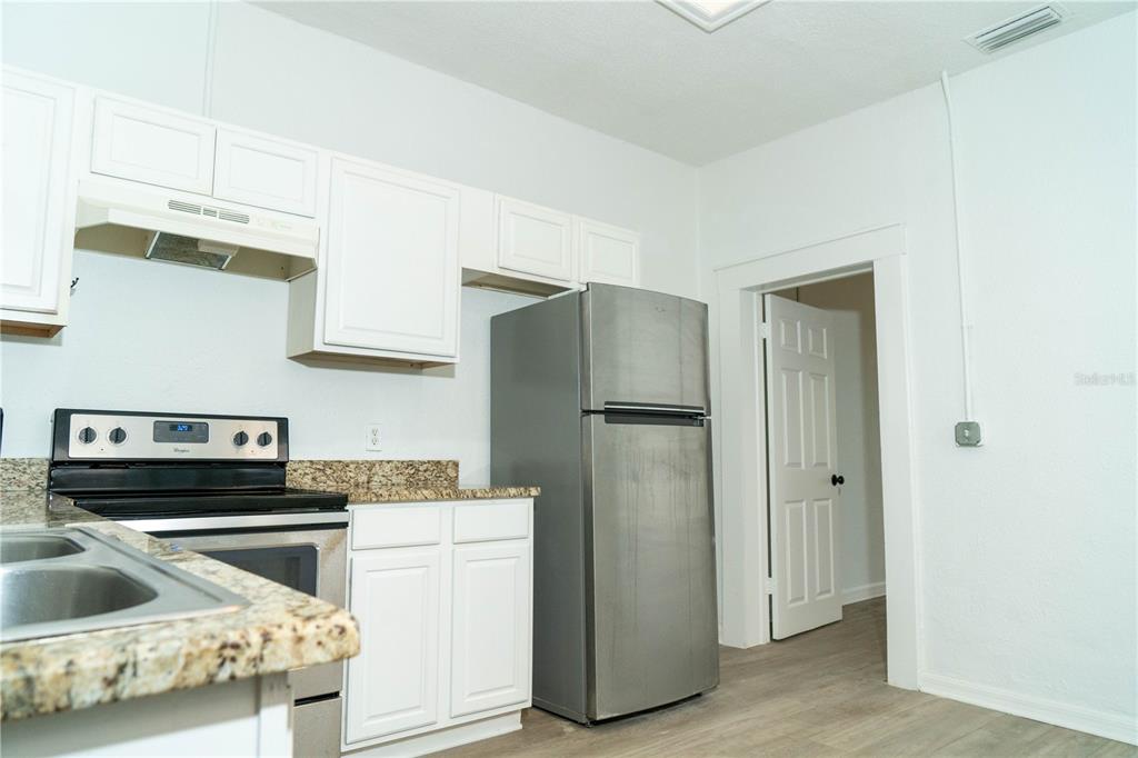 2906 West Chestnut Street, Unit 2 Tampa, FL 33607 - Photo 9 of 28 a kitchen with a refrigerator sink and cabinets