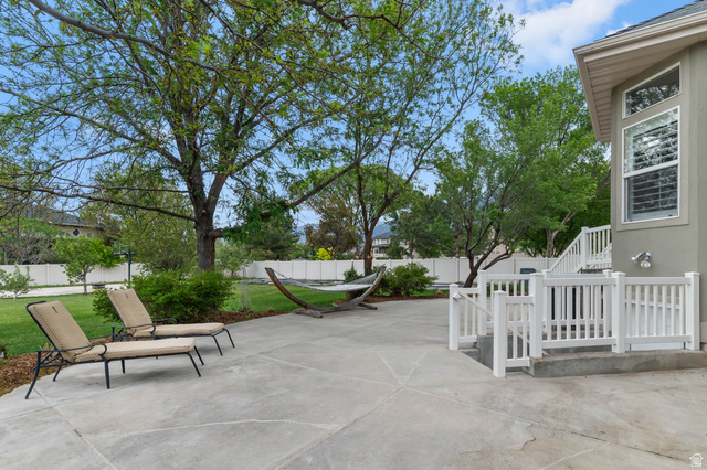 439 East 13540 South Draper, UT 84020 - Photo 38 of 46 Expansive concrete patio with white railing leading to the upper level