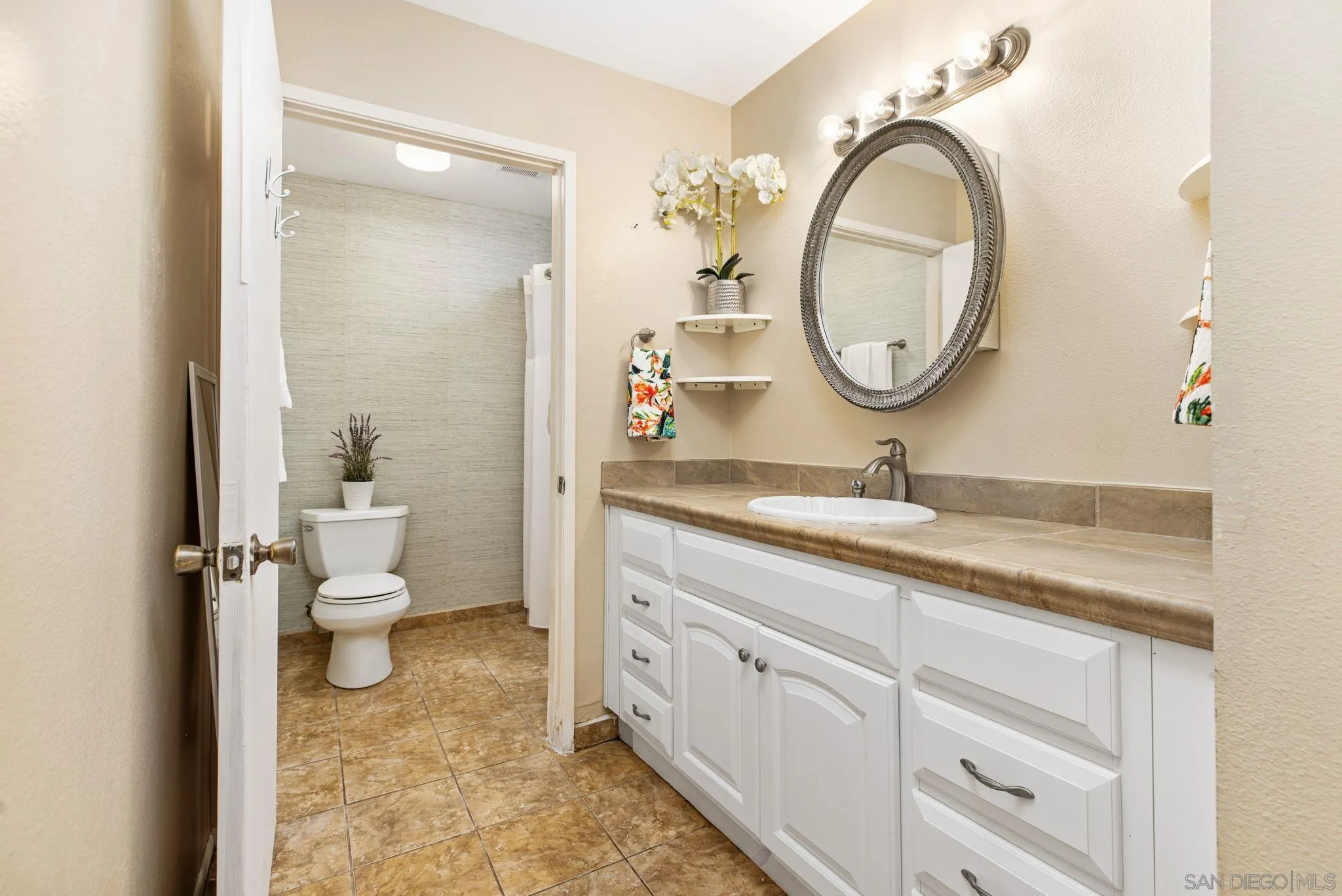 4121 Oak Island Lane Fallbrook, CA 92028 - Photo 11 of 25 a bathroom with a granite countertop toilet sink and mirror