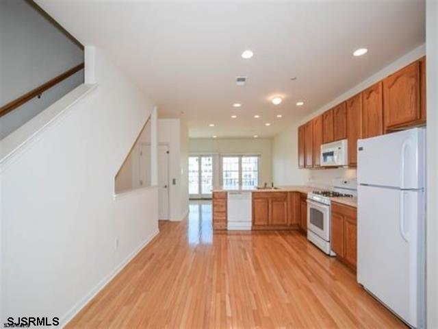 36 Chelsea Court, Unit 36 Atlantic City, NJ 08401 - Photo 2 of 23 a kitchen with a wooden floor and stainless steel appliances