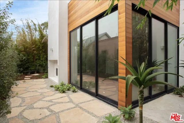 a view of potted plants with glass windows