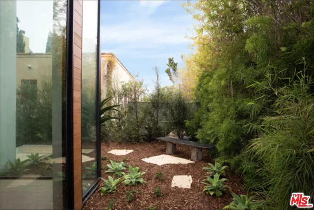 a view of a balcony with yard