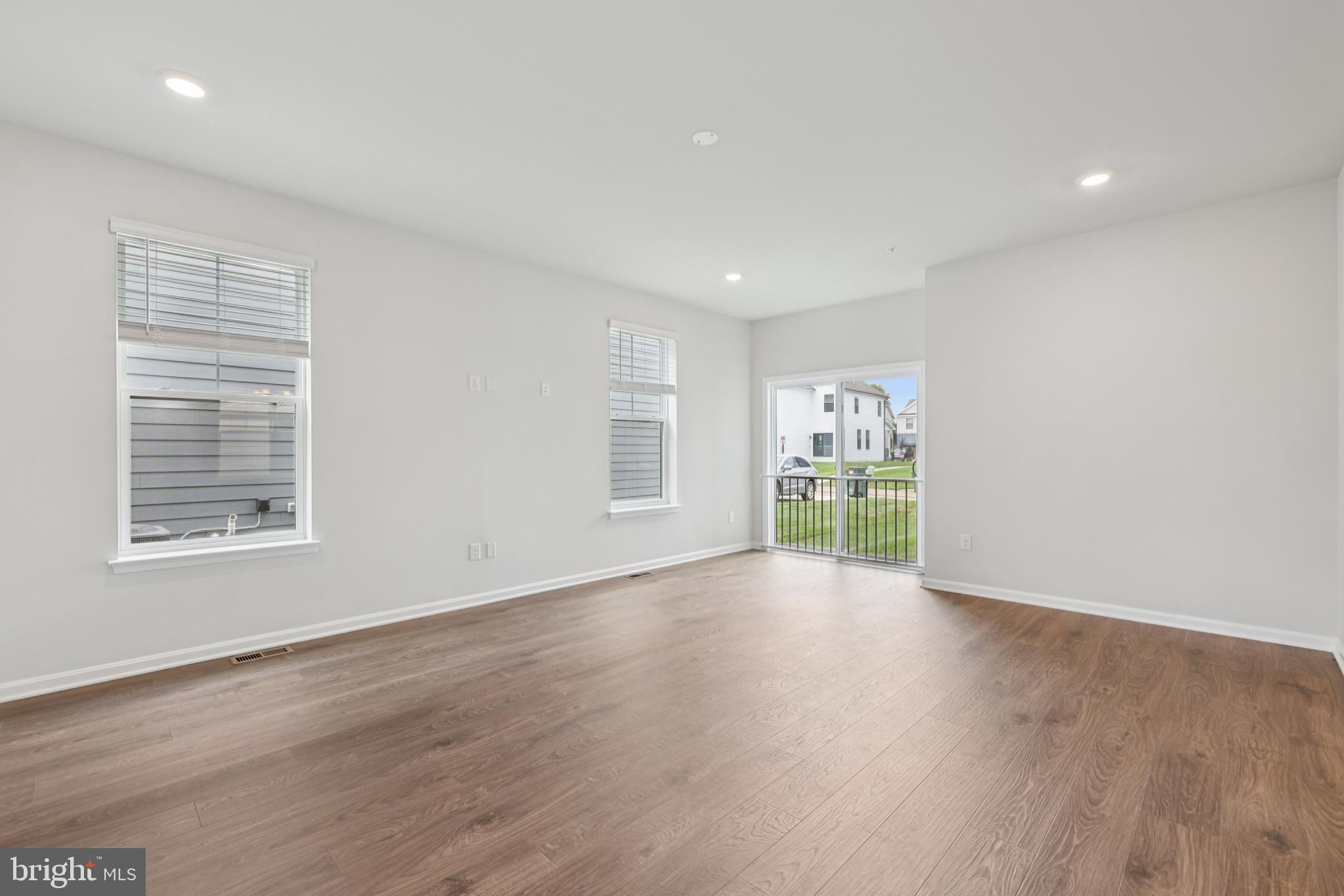470 Herringbone Way Frederick, MD 21701 - Photo 14 of 61 a view of an empty room with a window and wooden floor