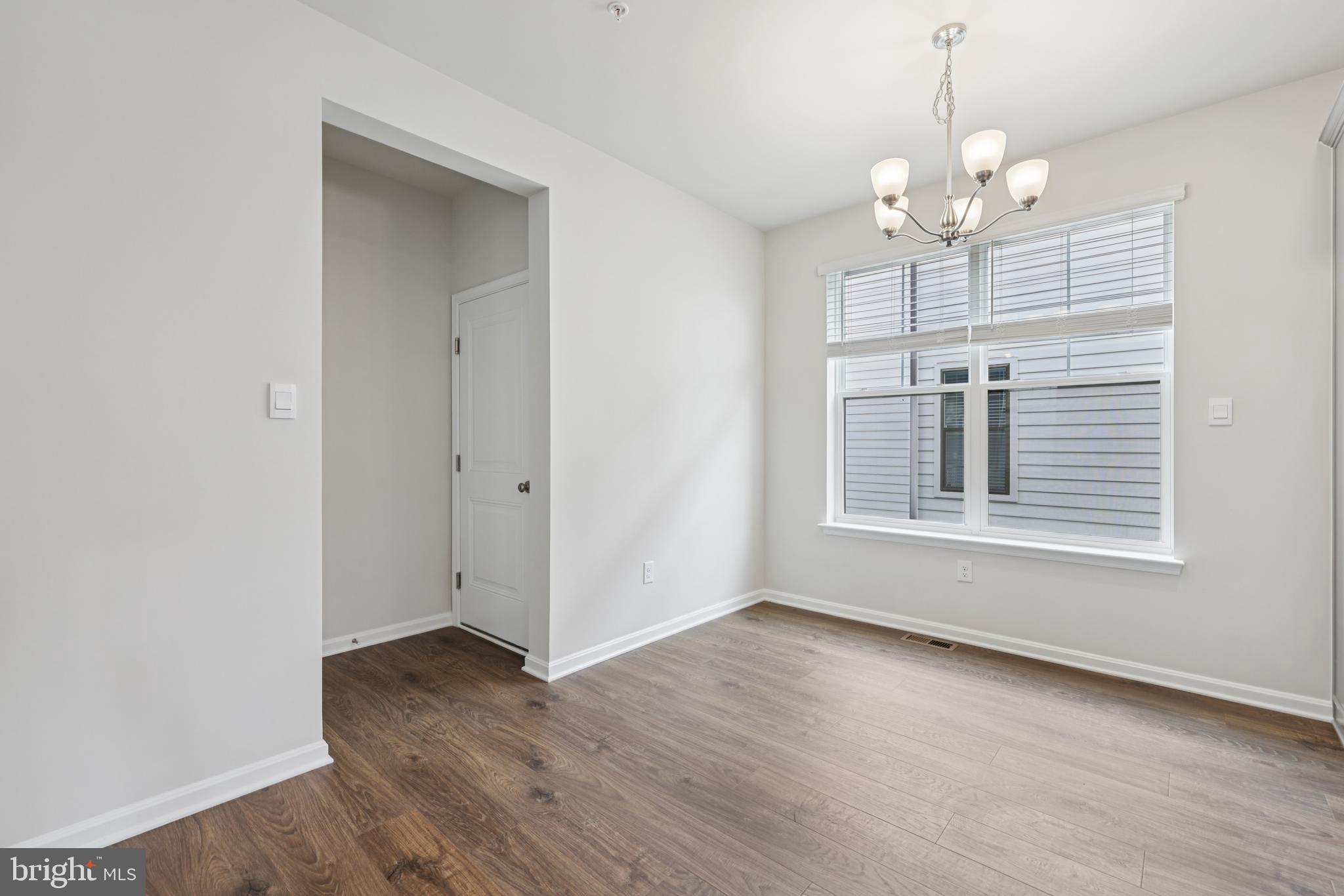 470 Herringbone Way Frederick, MD 21701 - Photo 16 of 61 a view of a livingroom with a chandelier hardwood floor and a ceiling fan