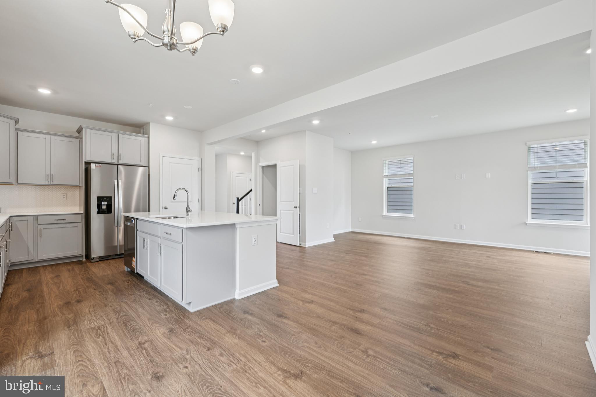 470 Herringbone Way Frederick, MD 21701 - Photo 17 of 61 a view of kitchen with refrigerator microwave and wooden floor