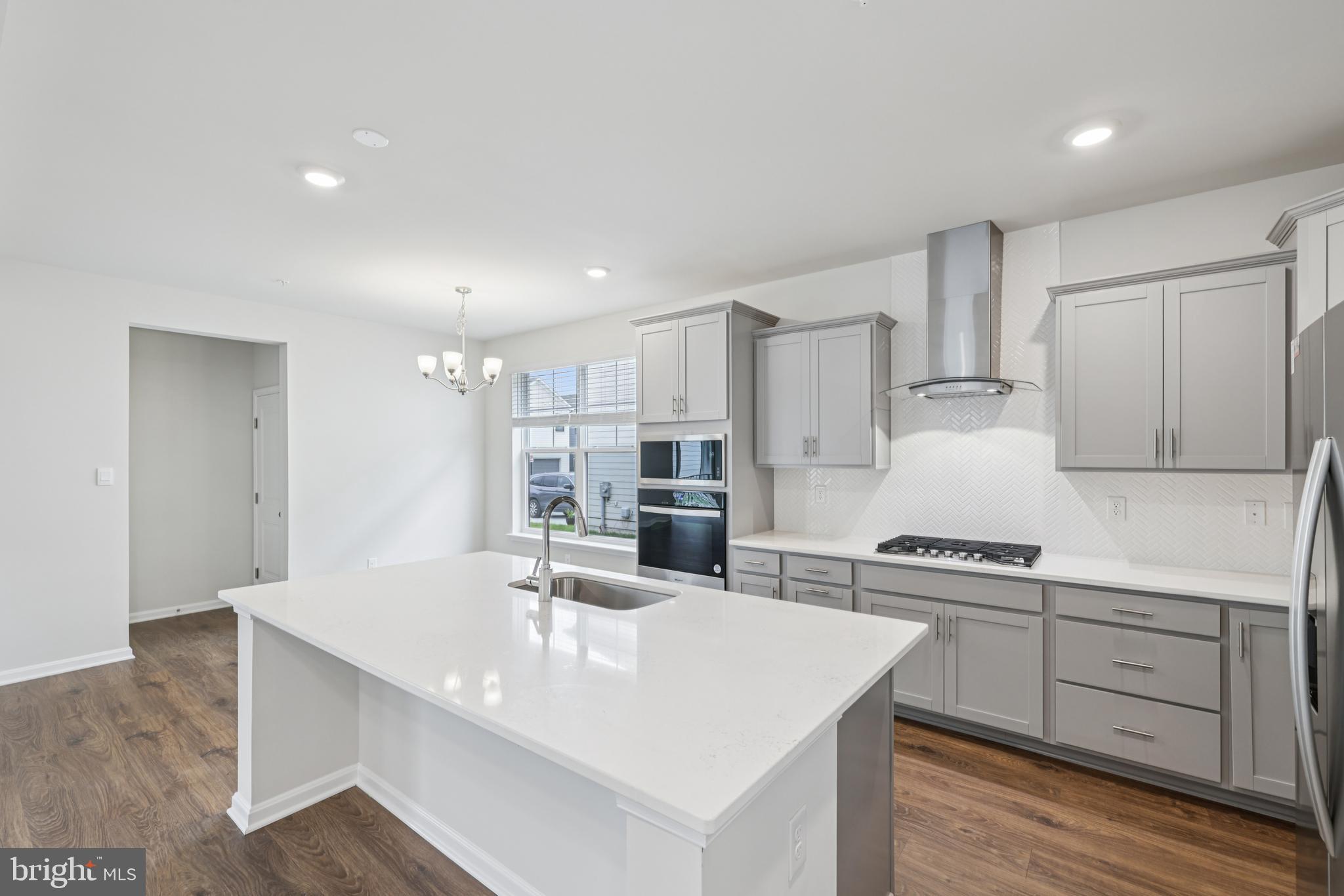 470 Herringbone Way Frederick, MD 21701 - Photo 19 of 61 a kitchen with stainless steel appliances kitchen island granite countertop a sink and white cabinets