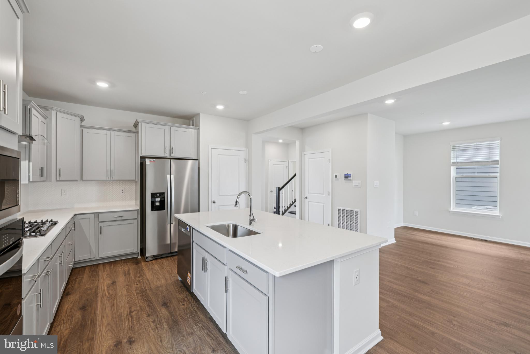 470 Herringbone Way Frederick, MD 21701 - Photo 23 of 61 a kitchen with white cabinets and stainless steel appliances