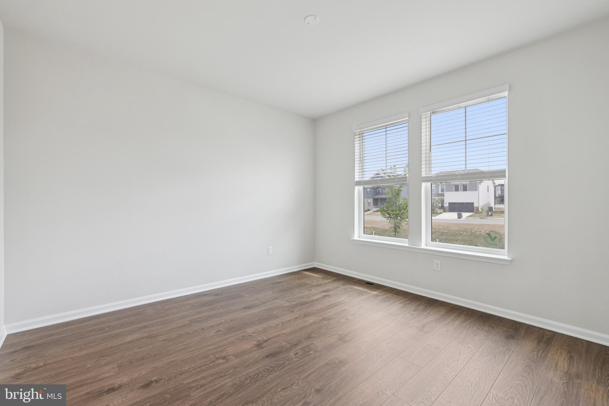470 Herringbone Way Frederick, MD 21701 - Photo 27 of 61 an empty room with wooden floor and windows