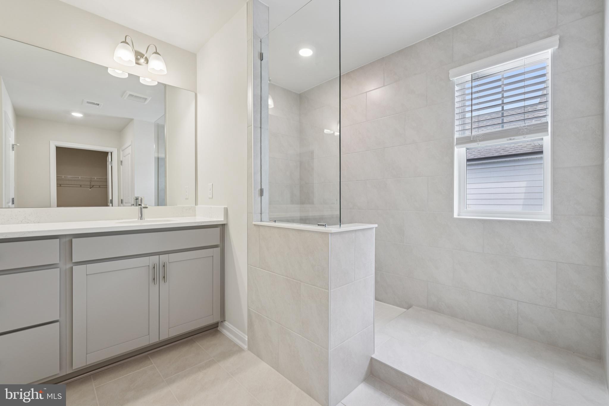 470 Herringbone Way Frederick, MD 21701 - Photo 48 of 61 a bathroom with a double vanity sink and a mirror