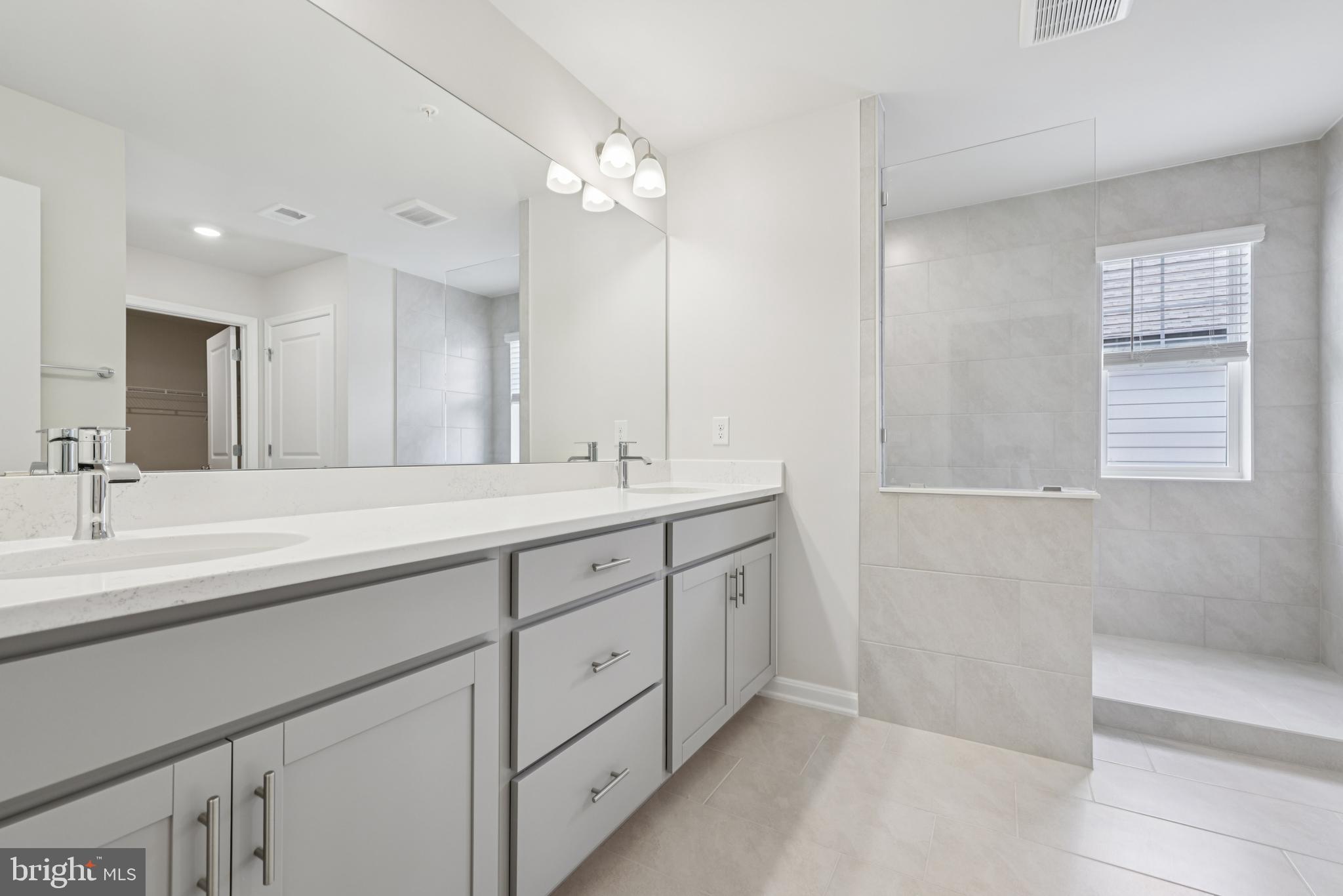 470 Herringbone Way Frederick, MD 21701 - Photo 51 of 61 a bathroom with double sink and a mirror