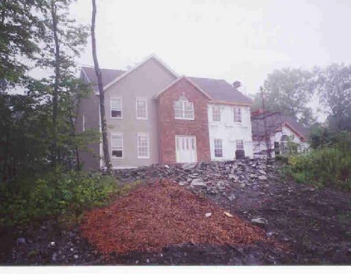 9 High Ridge Road Southbury, CT 06488 - Photo 1 of 1 a view of a brick house next to a yard with large trees