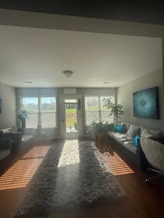 a living room with furniture and a floor to ceiling window