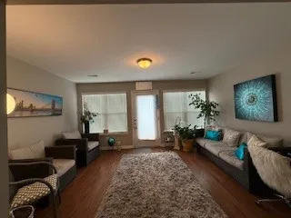 a living room with furniture and wooden floor