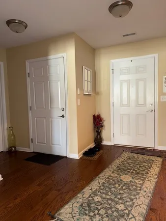 a view of an entryway with wooden floor