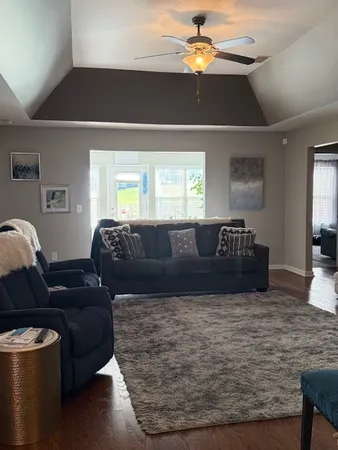 a living room with furniture and a chandelier