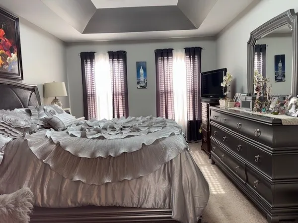 a living room with a bed and a flat screen tv