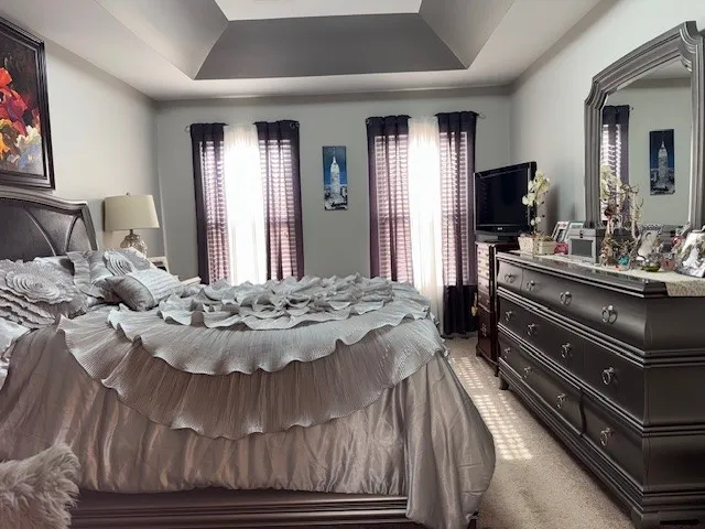 a living room with a bed and a flat screen tv