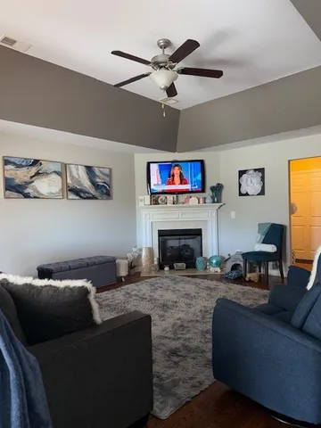 a living room with furniture and a fireplace