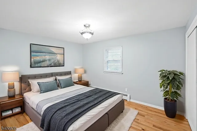 a bedroom with a bed and a potted plant