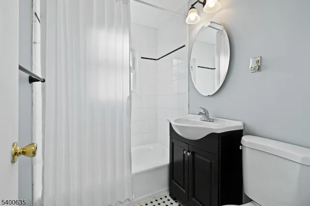 a bathroom with a sink a mirror and a toilet