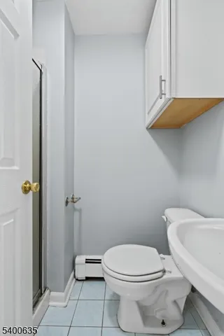 a white toilet sitting next to a bathroom sink