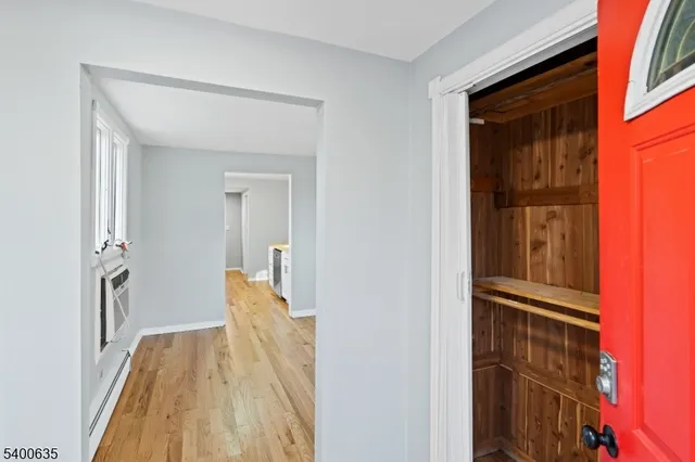 a view of hallway with wooden floor