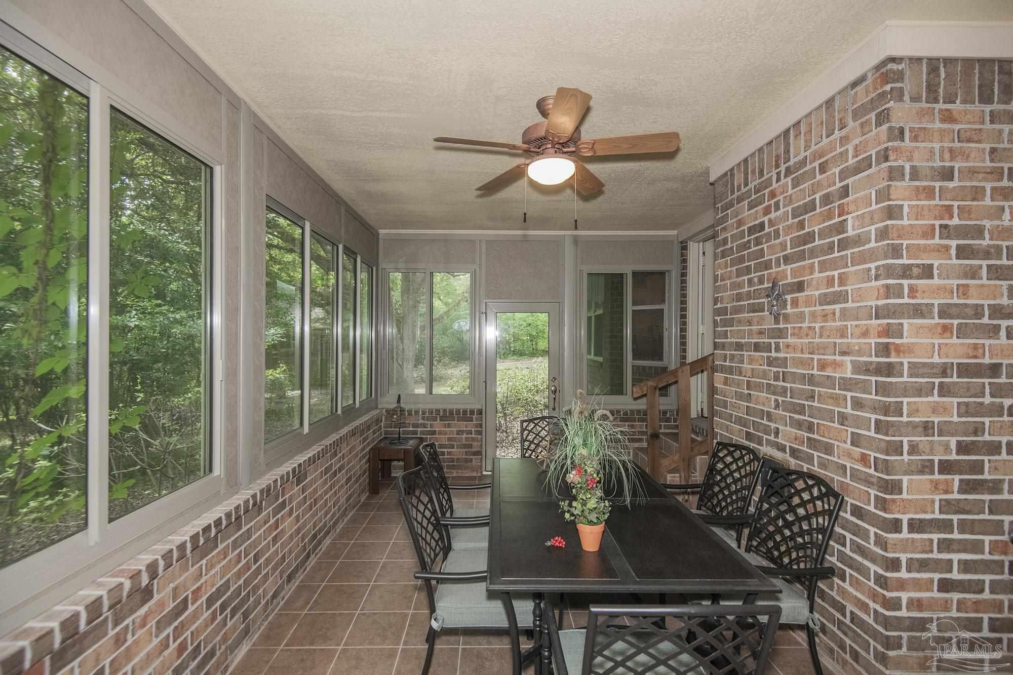 1210 Goldenrod Road Cantonment, FL 32533 - Photo 34 of 50 a view of a dining room with furniture window and outside view