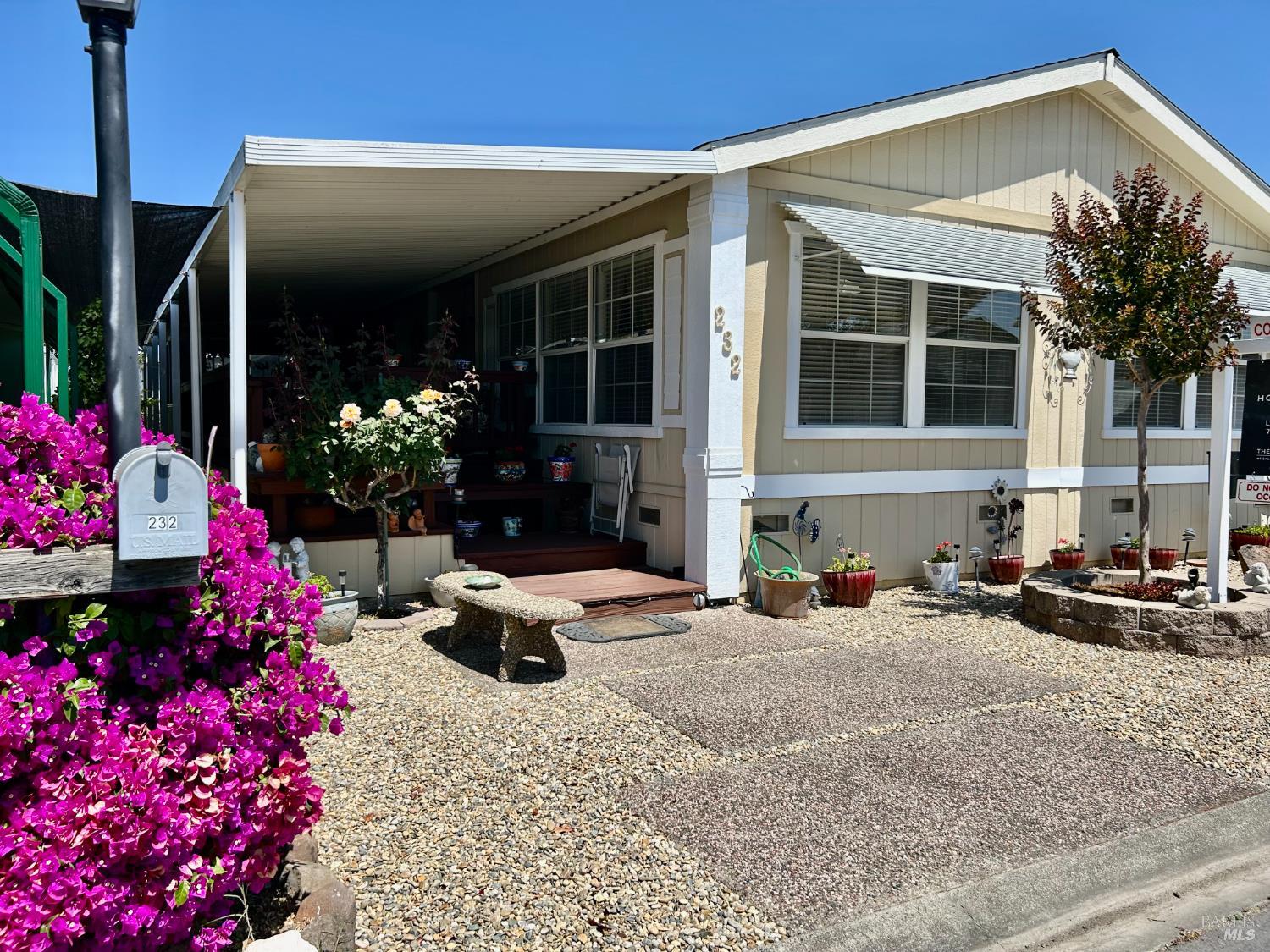 a view of a house that has a flower garden