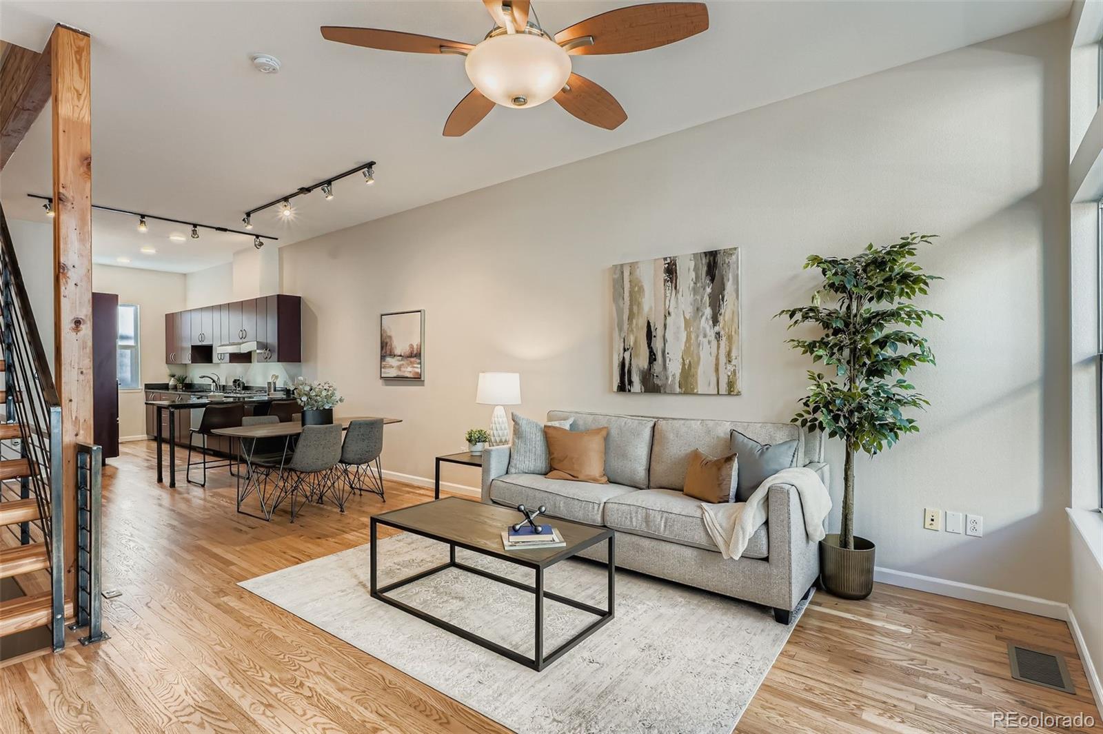 2680 Blake Street, Unit 18 Denver, CO 80205 - Photo 1 of 29 a living room with furniture and a potted plant