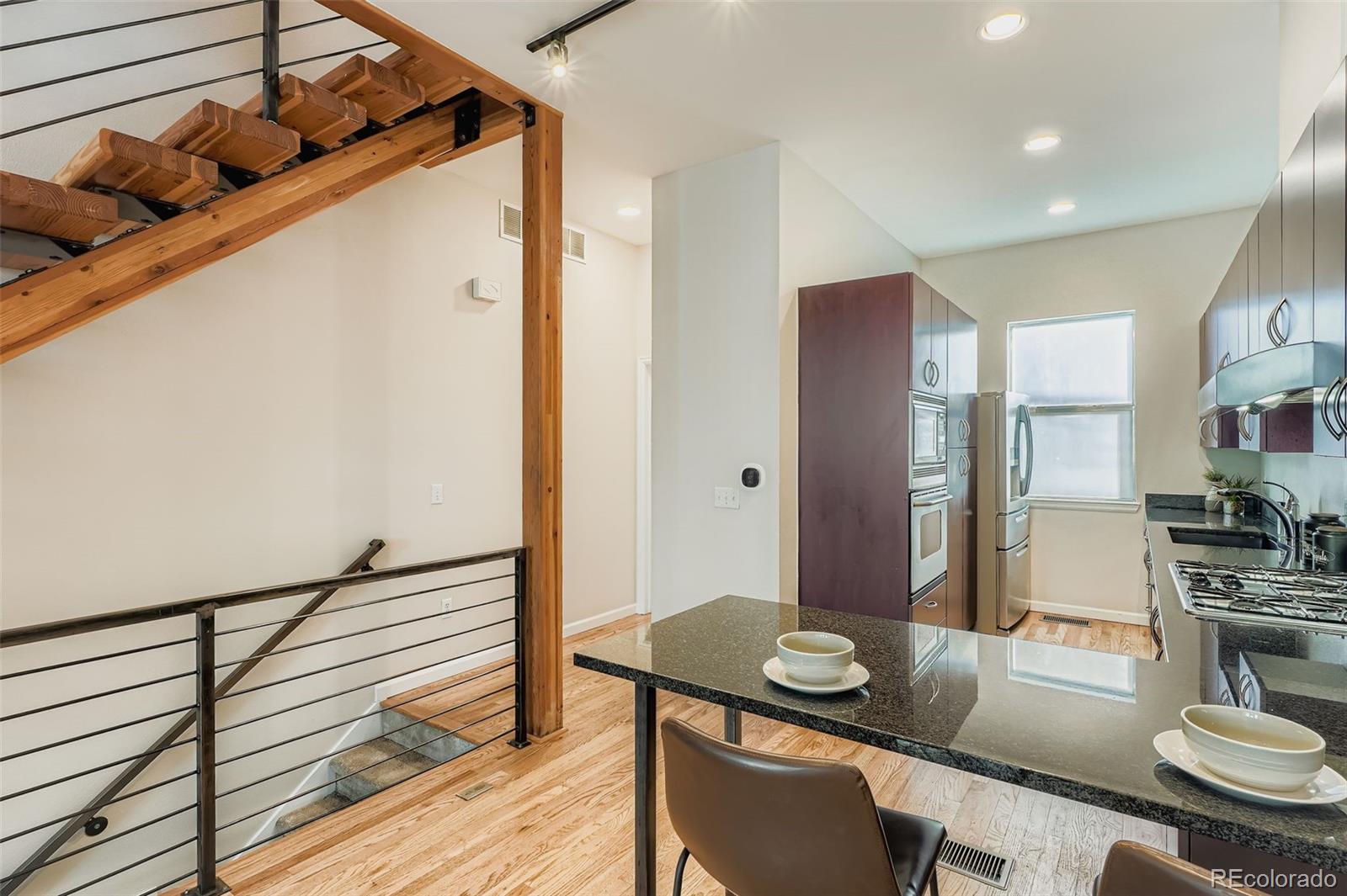 2680 Blake Street, Unit 18 Denver, CO 80205 - Photo 11 of 29 a kitchen with a table and chairs