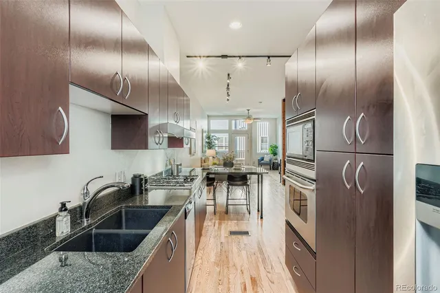 a kitchen with cabinets a sink stainless steel appliances and a counter top space