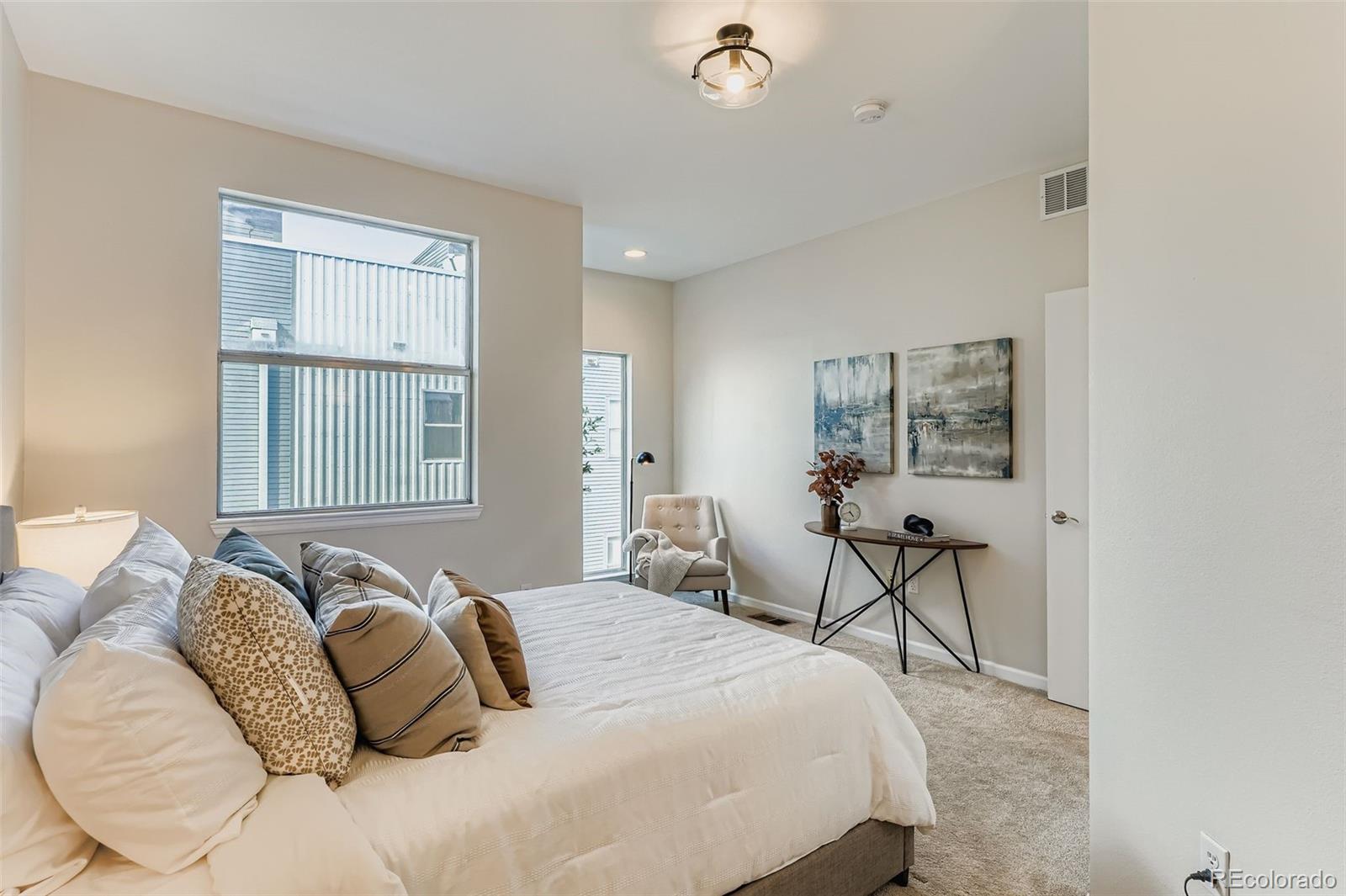 2680 Blake Street, Unit 18 Denver, CO 80205 - Photo 15 of 29 a bedroom with a large bed and a window