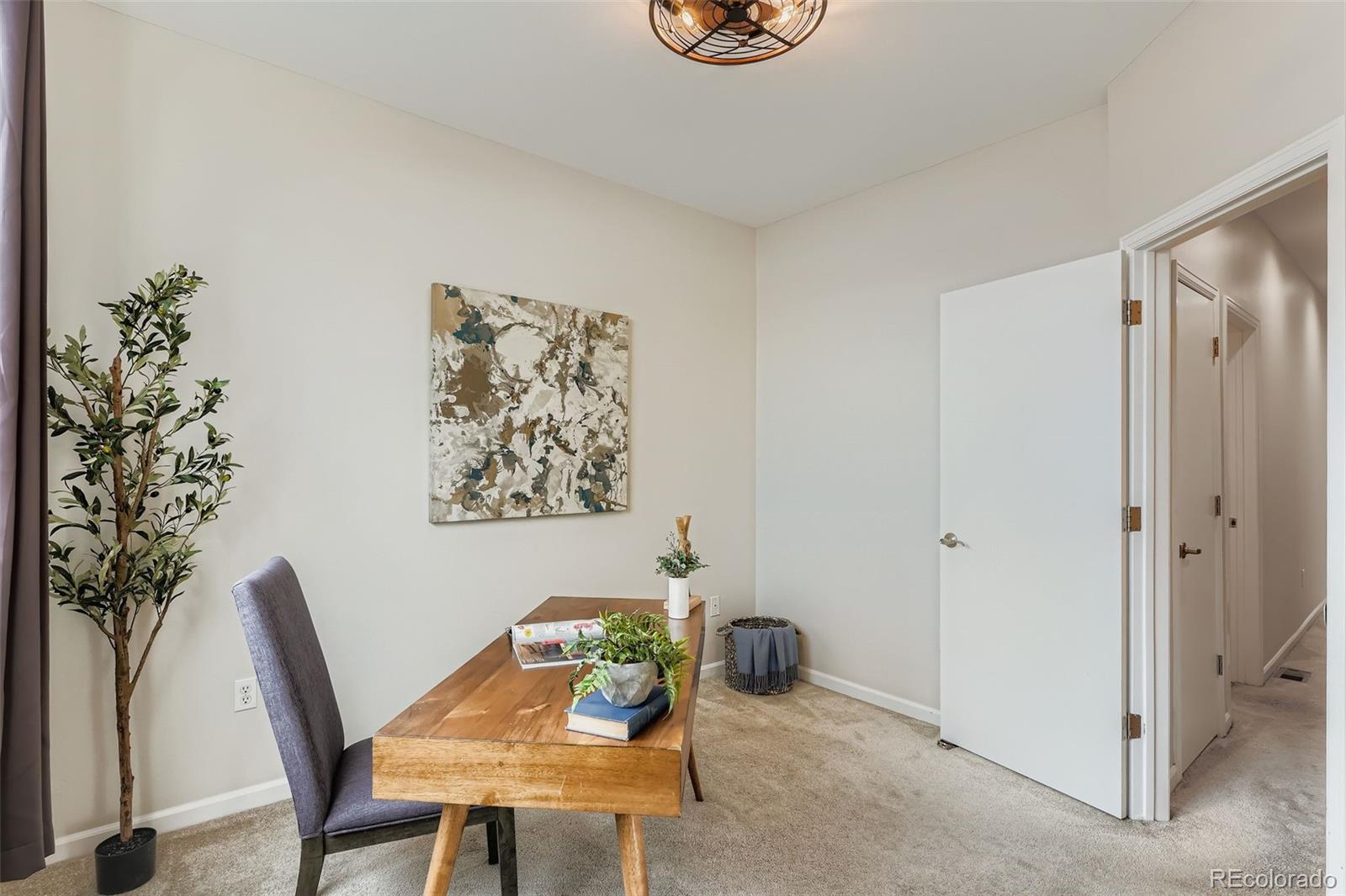 2680 Blake Street, Unit 18 Denver, CO 80205 - Photo 20 of 29 a view of a livingroom with furniture and a potted plant