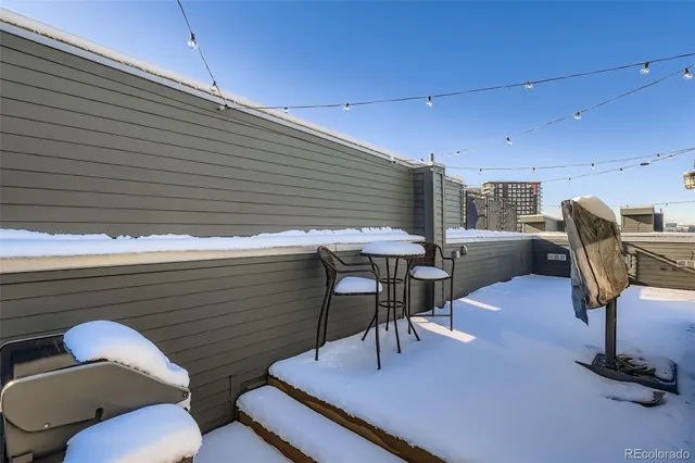 a balcony with table and chairs