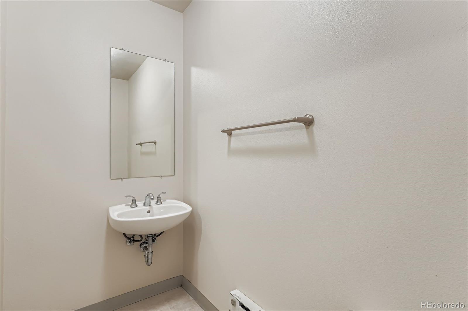 2680 Blake Street, Unit 18 Denver, CO 80205 - Photo 24 of 29 a bathroom with a sink mirror and vanity
