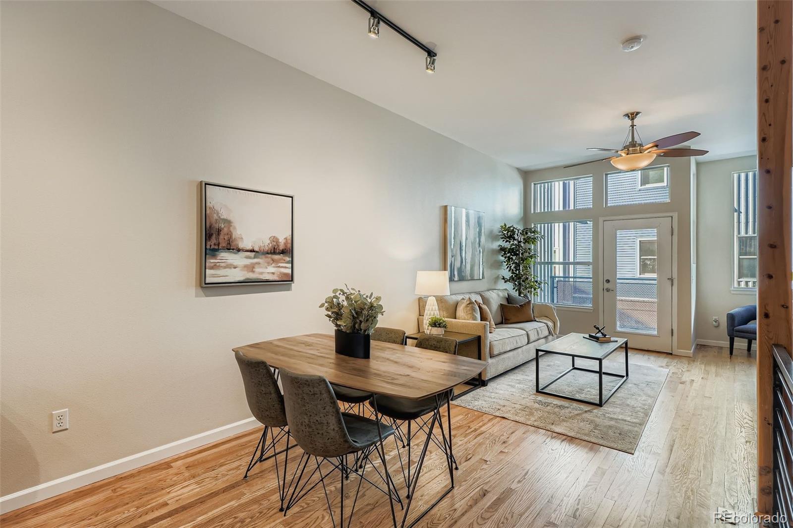 2680 Blake Street, Unit 18 Denver, CO 80205 - Photo 7 of 29 a view of a dining room with furniture and wooden floor