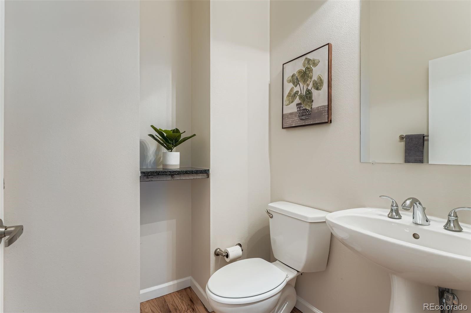 2680 Blake Street, Unit 18 Denver, CO 80205 - Photo 9 of 29 a white toilet sitting next to a bathroom sink