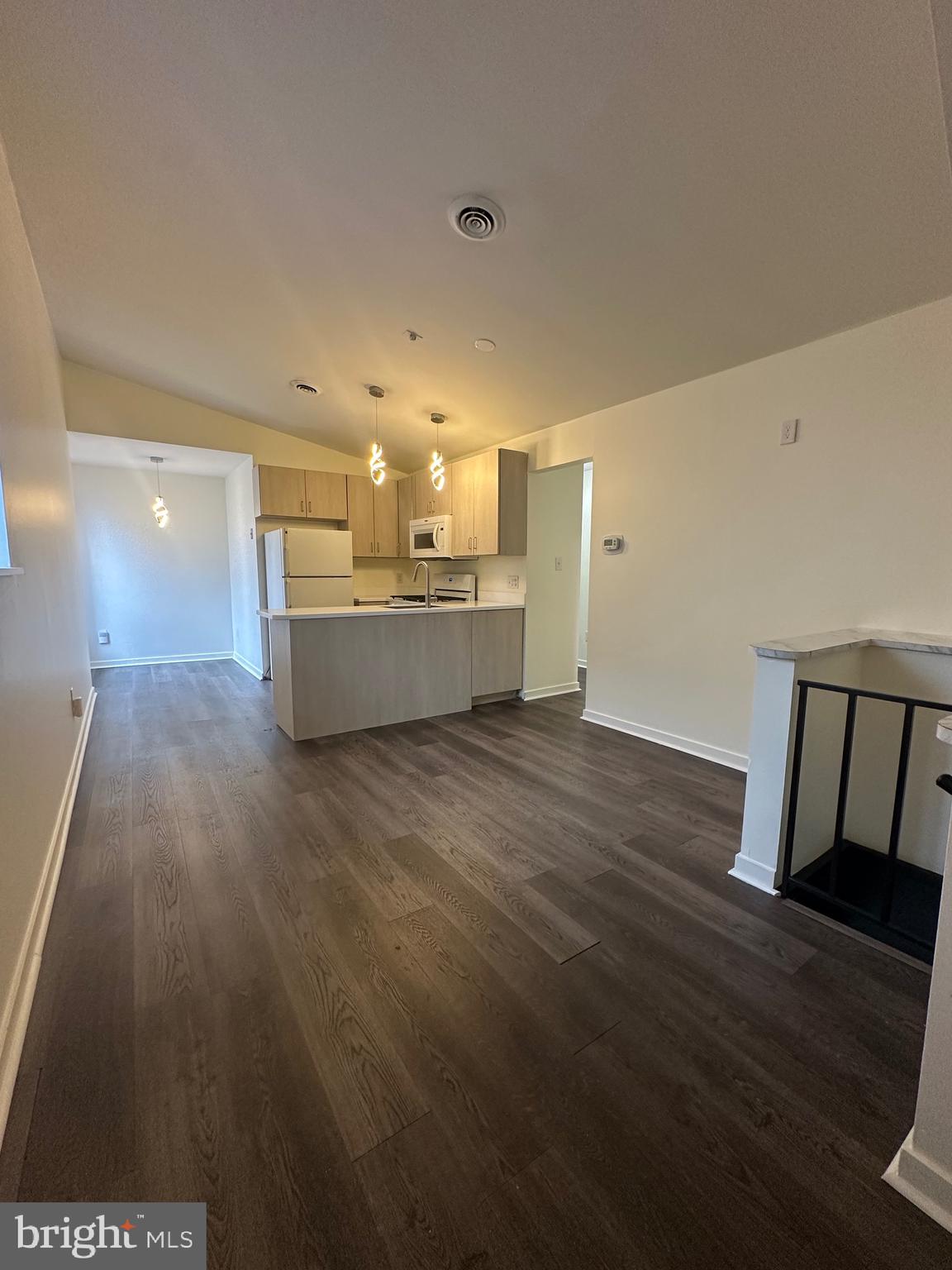 a view of a living room and kitchen with furniture